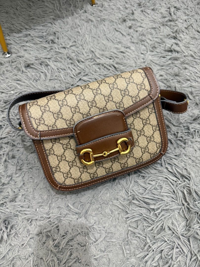 Gucci Supreme Horsebit Mini (Category: Luxury Bags & Wallets) located in Quezon City. Submitted by ashhaul (Listing ID 1468571241, Image 1). Description: - Gucci shoulder bag - Crafted in iconic GG Supreme canvas - Brown leather trim with contrast white stitching - Gold-tone hardware featuring signature horsebit detail - Secure flap closure - Brown fabric-lined interior with multiple compartments and a zippered pocket - Includes a removable brown