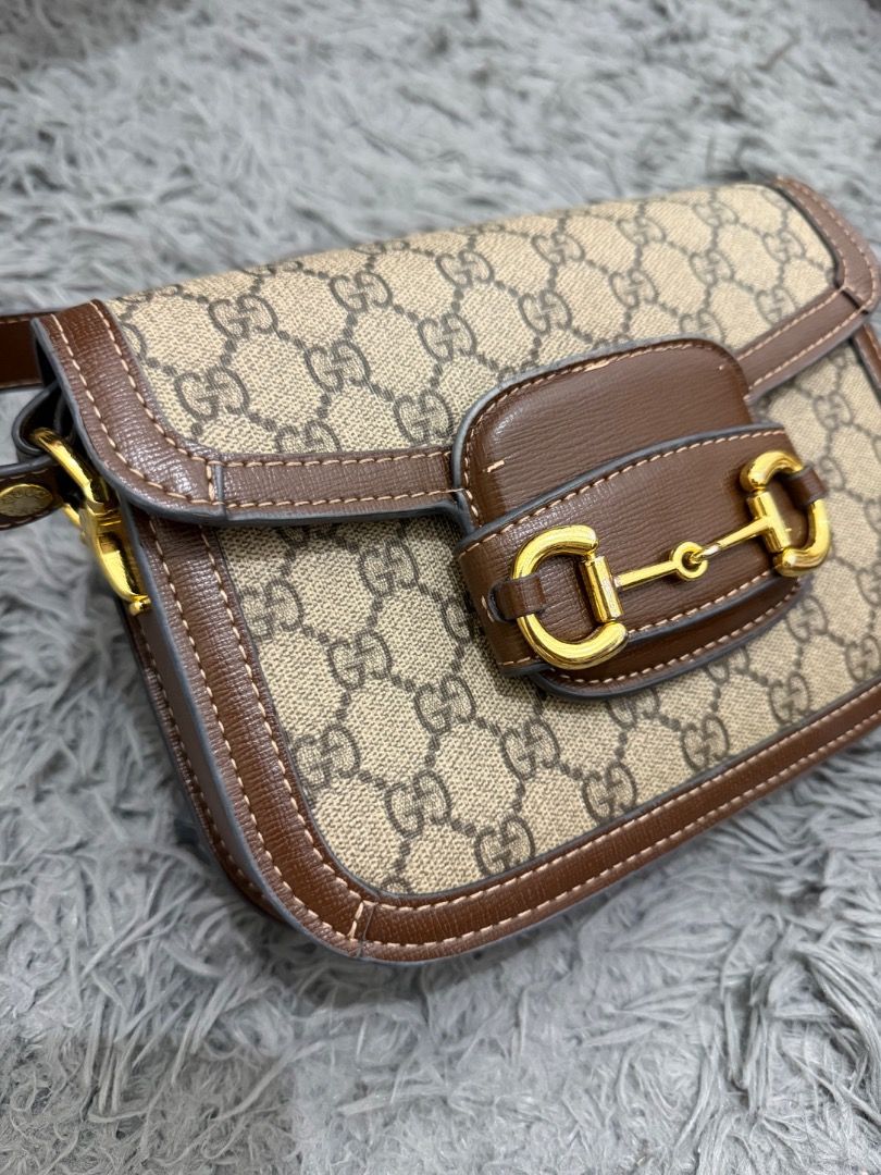 Gucci Supreme Horsebit Mini (Category: Luxury Bags & Wallets) located in Quezon City. Submitted by ashhaul (Listing ID 1468571241, Image 3). Description: - Gucci shoulder bag - Crafted in iconic GG Supreme canvas - Brown leather trim with contrast white stitching - Gold-tone hardware featuring signature horsebit detail - Secure flap closure - Brown fabric-lined interior with multiple compartments and a zippered pocket - Includes a removable brown