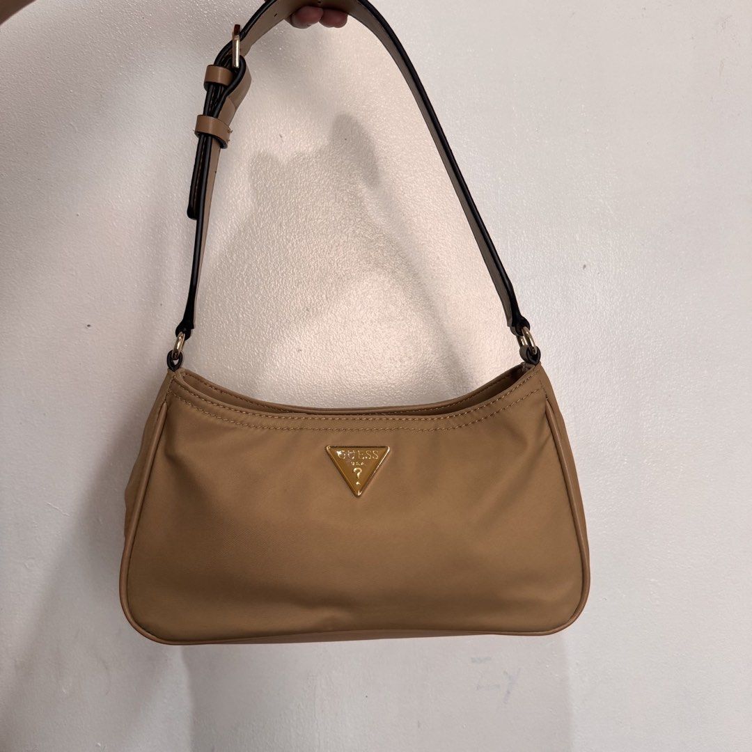 Guess Nylon Shoulder Bag Tan (Category: Shoulder Bags) located in Quezon City. Submitted by sage.ph (Listing ID 1468540954, Image 1). Description: - Authentic, no fakes here - Used twice only -Durable nylon with faux leather adjustable strap - Perfect size for date night / daily essentials .