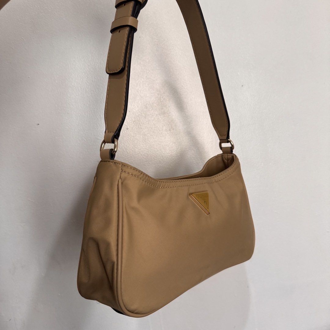 Guess Nylon Shoulder Bag Tan (Category: Shoulder Bags) located in Quezon City. Submitted by sage.ph (Listing ID 1468540954, Image 2). Description: - Authentic, no fakes here - Used twice only -Durable nylon with faux leather adjustable strap - Perfect size for date night / daily essentials .