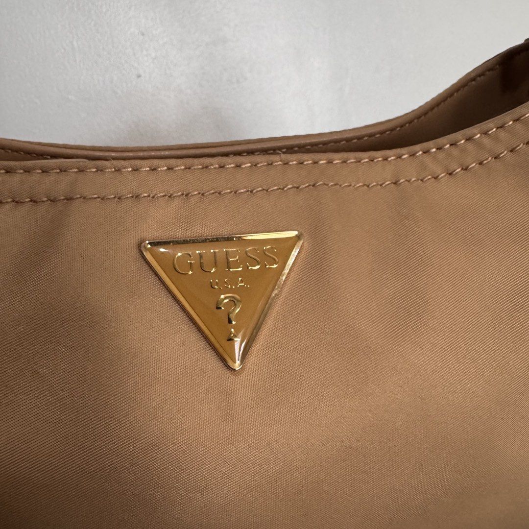 Guess Nylon Shoulder Bag Tan (Category: Shoulder Bags) located in Quezon City. Submitted by sage.ph (Listing ID 1468540954, Image 3). Description: - Authentic, no fakes here - Used twice only -Durable nylon with faux leather adjustable strap - Perfect size for date night / daily essentials .