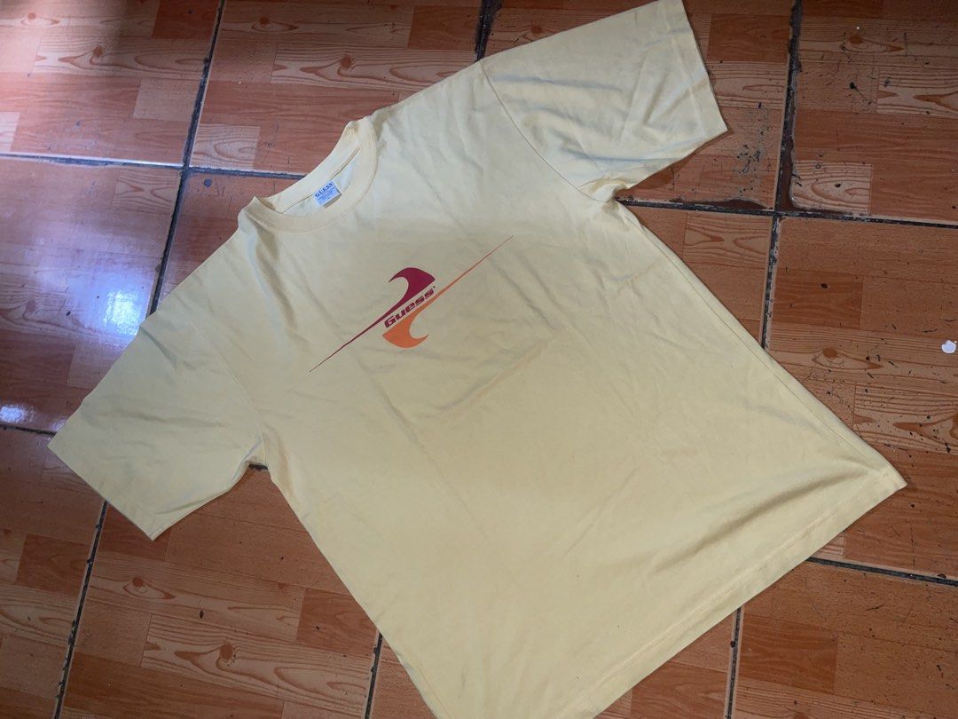 Guess Yellow Graphic Tee Size L (Category: Tshirts & Polo Shirts ) located in Manila. Submitted by joshua_guimeroy. (Listing ID 1468524417, Image 1). Description: - Brand: Guess - Size: Large - Condition: Brand new with tags attached - Material: 100% cotton - Fit: Relaxed fit with standard crew neck and short sleeves - Design: Retro front graphic featuring pink and orange waves with the Guess logo - Color: Yellow.