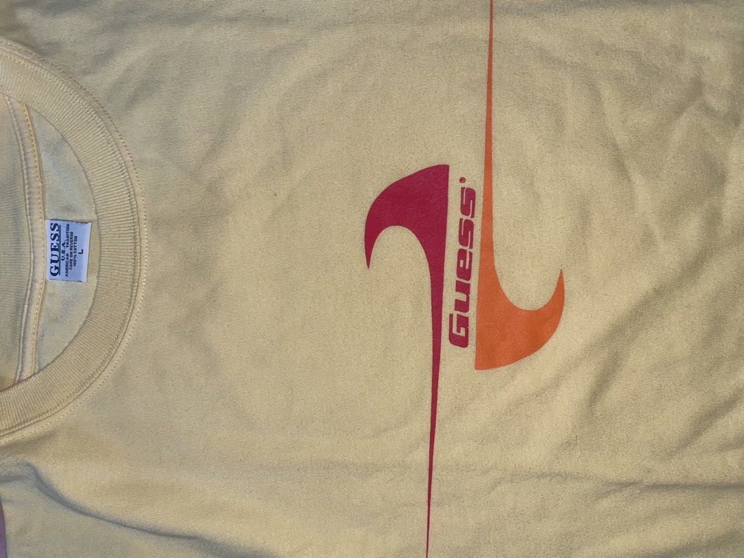 Guess Yellow Graphic Tee Size L (Category: Tshirts & Polo Shirts ) located in Manila. Submitted by joshua_guimeroy. (Listing ID 1468524417, Image 3). Description: - Brand: Guess - Size: Large - Condition: Brand new with tags attached - Material: 100% cotton - Fit: Relaxed fit with standard crew neck and short sleeves - Design: Retro front graphic featuring pink and orange waves with the Guess logo - Color: Yellow.