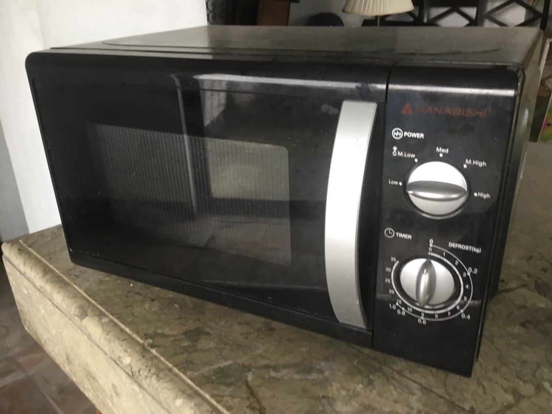 Hanabishi Black Microwave Oven with Rotating Dials (Category: Ovens & Toasters) located in Manila. Submitted by roberto.enriquez (Listing ID 1468692882, Image 2). Description: - Brand: Hanabishi - Color: Sleek black exterior with clean grey interior - Controls: Dual manual knobs for power and timer - Included: Glass turntable tray - Design: Standard countertop size with silver pull handle - Condition: Fully functional and ready to use.