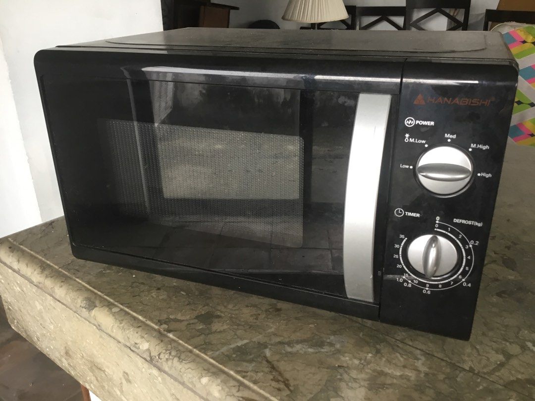 Hanabishi Black Microwave Oven with Rotating Dials (Category: Ovens & Toasters) located in Manila. Submitted by roberto.enriquez (Listing ID 1468692882, Image 1). Description: - Brand: Hanabishi - Color: Sleek black exterior with clean grey interior - Controls: Dual manual knobs for power and timer - Included: Glass turntable tray - Design: Standard countertop size with silver pull handle - Condition: Fully functional and ready to use.