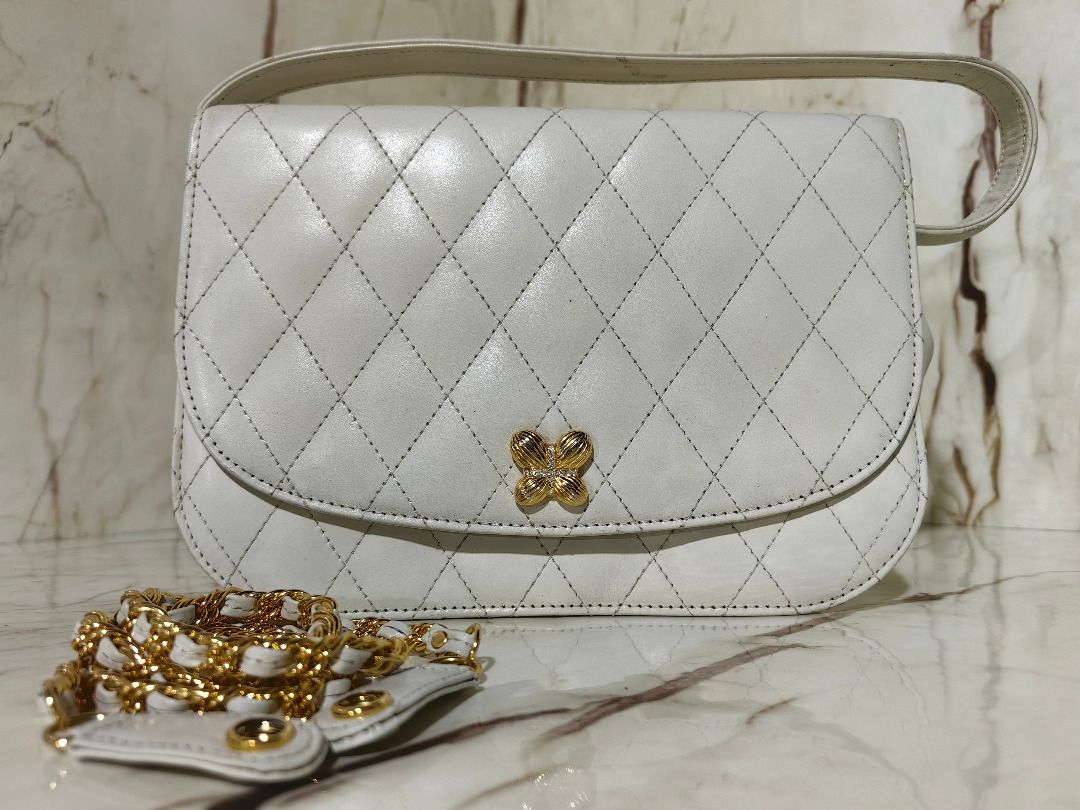 Hanae Mori White Quilted Handbag with Chain Strap (Category: Shoulder Bags) located in Tarlac. Submitted by jeremiah.curator.2026 (Listing ID 1468561048, Image 2). Description: - Brand: Hanae Mori - Color: Classic white with elegant quilted pattern - Hardware: Gold-tone hardware with secure front clasp closure - Straps: Includes a standard top handle and a detachable gold chain strap - Interior: Features official Hanae Mori brand plaque - Conditi