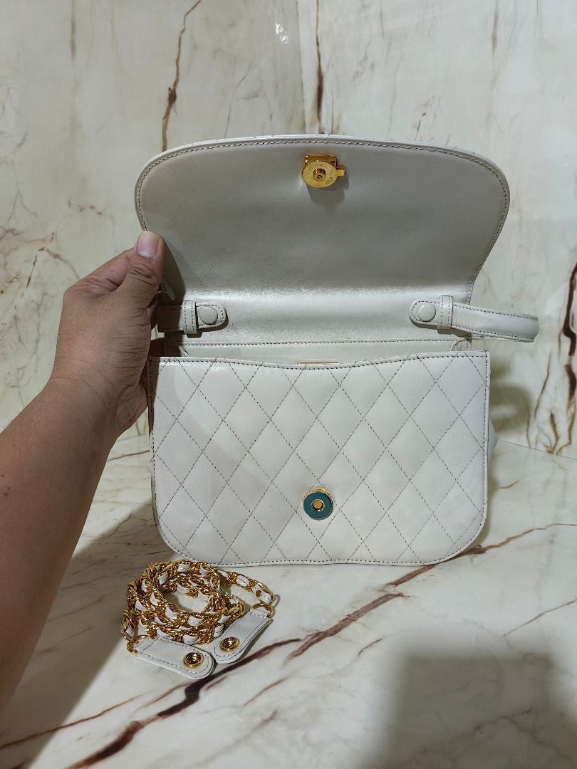 Hanae Mori White Quilted Handbag with Chain Strap (Category: Shoulder Bags) located in Tarlac. Submitted by jeremiah.curator.2026 (Listing ID 1468561048, Image 3). Description: - Brand: Hanae Mori - Color: Classic white with elegant quilted pattern - Hardware: Gold-tone hardware with secure front clasp closure - Straps: Includes a standard top handle and a detachable gold chain strap - Interior: Features official Hanae Mori brand plaque - Conditi