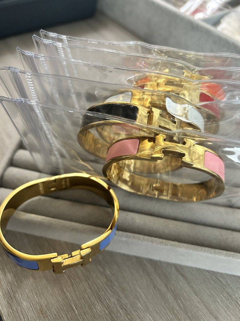 H-clasp Enamel Gold Cuff Bangle (Category: Bracelets) located in Manila. Submitted by elonlineshop (Listing ID 1468501836, Image 2). Description: - Material: Gold-plated metal with enamel insets and polished finish - Design: Iconic H-clasp with convenient hinged opening - Colors available: Pink, Black, White, Red and Orange - Condition: Brand new, several pieces still sealed in individual plastic sleeves - Styling: Great stackable accessories for