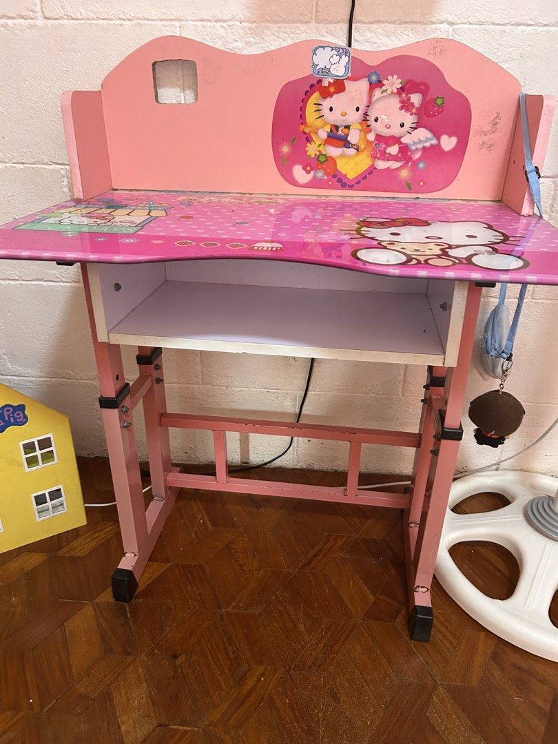 Hello Kitty Kids Study Table and Chair Set Pink (Category: Kids Tables & Chairs) located in Las Pinas. Submitted by gayle_r (Listing ID 1468564699, Image 1). Description: - Pink Kitty study desk and matching chair set - Features a built-in storage shelf under the desktop - Adjustable pink metal frames for both desk and chair - Fully functional and sturdy for studying, writing, or drawing - Flaws to note: Noticeable crack on the chair backrest, pl