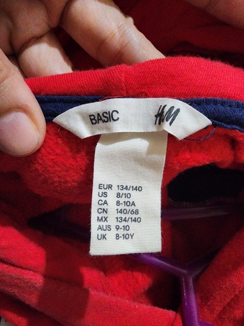 H&M Basic Hoodie Red Blue Size 8-10Y (Category: Babies & Kids Fashion) located in Valenzuela. Submitted by teachermommyph (Listing ID 1468553441, Image 2). Description: - Brand: H&M - Item: Basic Kids Hoodie - Color: Red with dark blue front pocket panel - Size: EUR 134/140 | US 8/10 | UK 8-10Y - Material: Soft fleece lining inside for extra warmth - Features: Long sleeves with ribbed cuffs - Condition: Great everyday sweatshirt, very comfy!.