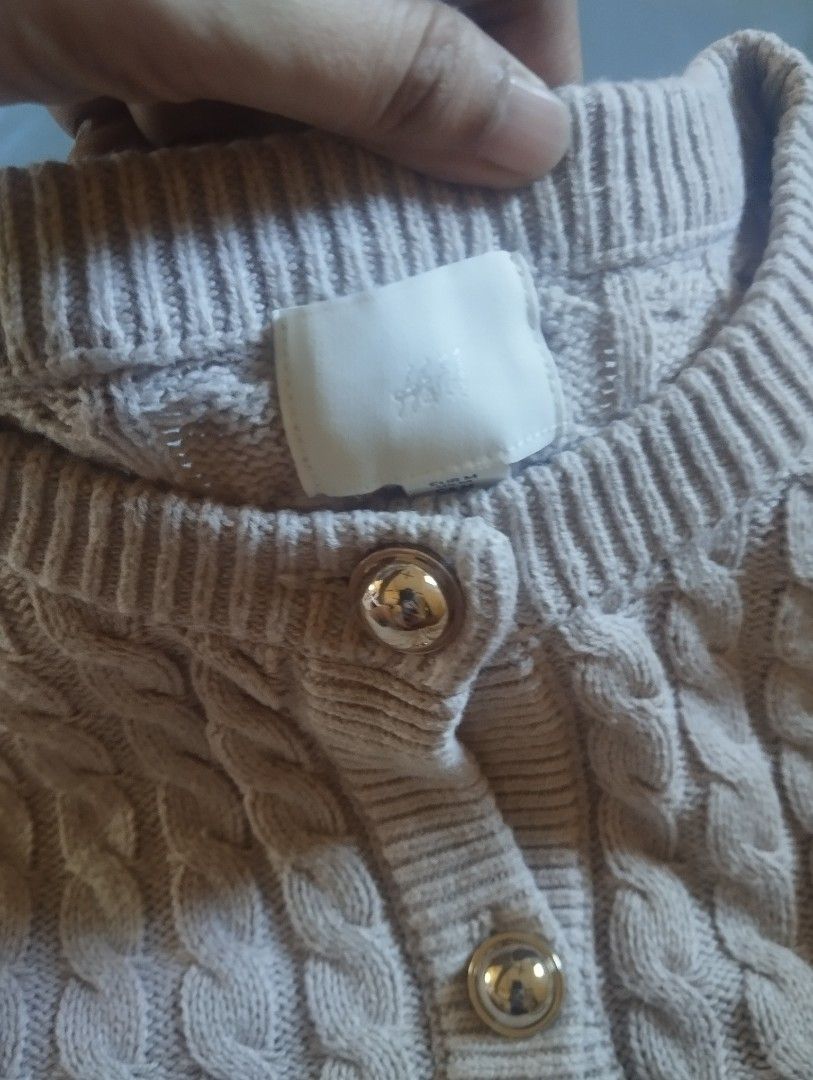 H&M Cable Knit Short Sleeve Cardigan (Category: Coats, Jackets and Outerwear) located in Manila. Submitted by ljaneee (Listing ID 1468553611, Image 3). Description: - Brand/Style: H&M short-sleeve cable knit cardigan - Color: Neutral beige - Size: Medium (M) - Details: Crew neck, thick textured knit, shiny gold-tone round buttons, ribbed collar, cuffs, and hem - Condition: Clean fabric, no pulls or loose threads - Styling: Easy to pair with high-