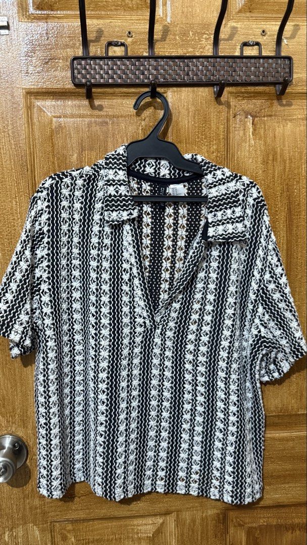 H&M Hole-Patterned Collared Top (Category: Shirts) located in Makati City. Submitted by andrae.thomas (Listing ID 1468682061, Image 2). Description: - Brand: H&M Divided - Style: Open knit polo shirt with V-neck collar and short sleeves - Color: Black and white with vertical stripe texture - Size: M - Loc: Makati. - Meet Up: Taft, DLSU, CSB.