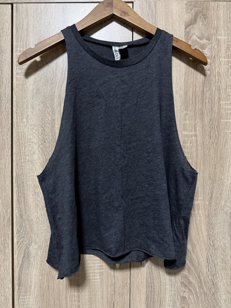 H&M Racer Back top (Category: Sleeveless) located in Bulacan. Submitted by relove.re (Listing ID 1468502176, Image 1). Description: H&M Singapore Dark Gray Sleeveless Top / Racer Back Size M * Color: Dark gray / charcoal * Style: Round neck, sleeveless, oversized fit * Design: Plain and minimalist with wide armholes * Material: Soft-looking, lightweight fabric * Condition: Please see photos for actual condition Perfect for casual wear, gym outfit