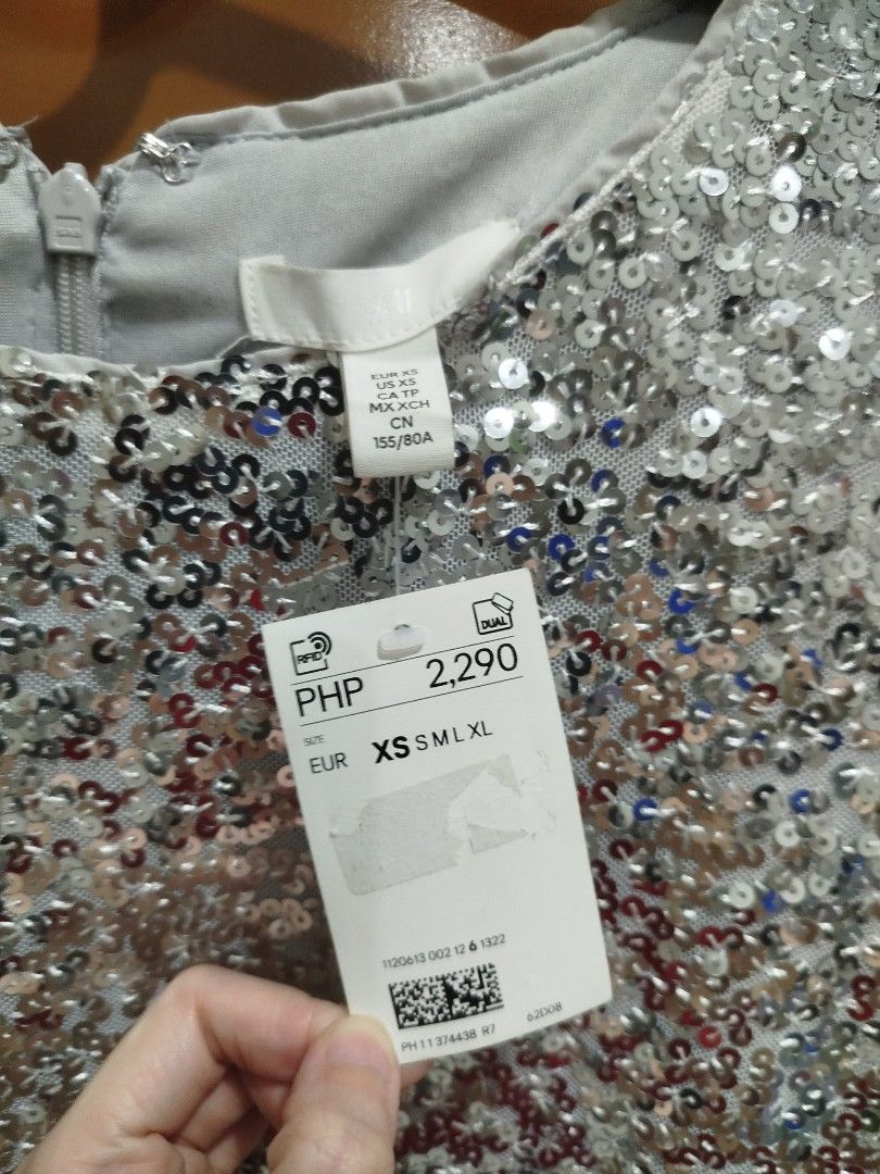 H&M Sequined Dress - Silver XS (Category: Dresses) located in Quezon City. Submitted by luckycitrine (Listing ID 1468565309, Image 3). Description: - Brand new with tags (BNWT) with retail price on tag - Color: Silver - Design: Round neckline, long sleeves, and back zipper closure - Material: Fully lined inside with all-over shimmering sequins - Occasion: Extra sparkly piece, perfect for parties and night outs - Ships via Grab/Lalamove from Noval