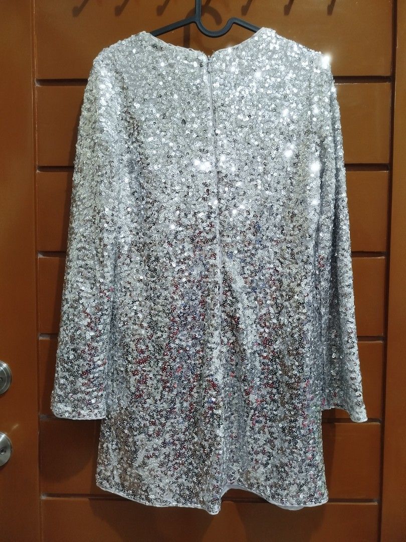 H&M Sequined Dress - Silver XS (Category: Dresses) located in Quezon City. Submitted by luckycitrine (Listing ID 1468565309, Image 2). Description: - Brand new with tags (BNWT) with retail price on tag - Color: Silver - Design: Round neckline, long sleeves, and back zipper closure - Material: Fully lined inside with all-over shimmering sequins - Occasion: Extra sparkly piece, perfect for parties and night outs - Ships via Grab/Lalamove from Noval