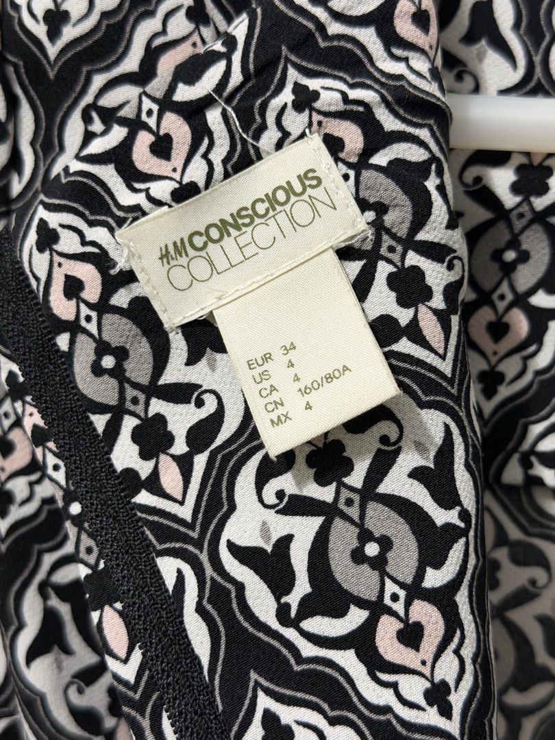 H&M Skater Dress (Category: Dresses) located in Malolos. Submitted by eadiana (Listing ID 1468570949, Image 3). Description: - Brand: H&M Conscious Collection - Size: EUR 34 / US 4 / CN 160/80A - Color/Pattern: Black, white, and pink intricate damask print - Design: Short sleeves with button cuffs, fitted waist, and flared skirt - Closure: Convenient back zip closure - Condition: Great piece for casual outings or dressing up - Lightweight and com