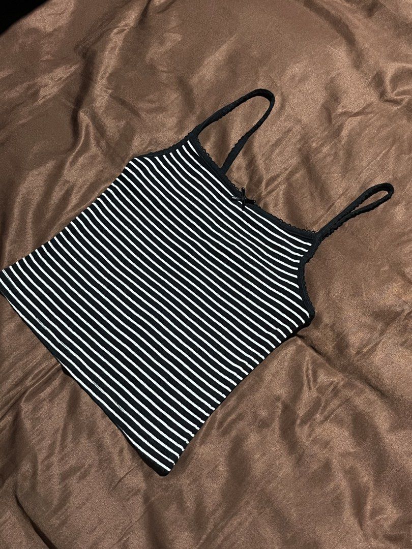 H&M Striped Ribbed Top Size XS (Category: Sleeveless) located in Manila. Submitted by maaya.rikit (Listing ID 1468621012, Image 2). Description: - Brand: H&M - Size: XS - Color/Pattern: Black and white stripes - Material: Stretchy, comfortable ribbed fabric - Design: Thin spaghetti straps with a cute center front bow - Versatility: Great basic piece for layering or wearing on its own.
