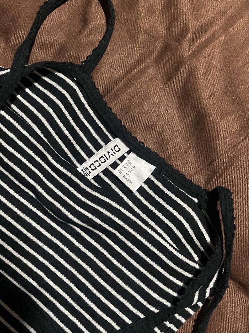 H&M Striped Ribbed Top Size XS (Category: Sleeveless) located in Manila. Submitted by maaya.rikit (Listing ID 1468621012, Image 3). Description: - Brand: H&M - Size: XS - Color/Pattern: Black and white stripes - Material: Stretchy, comfortable ribbed fabric - Design: Thin spaghetti straps with a cute center front bow - Versatility: Great basic piece for layering or wearing on its own.