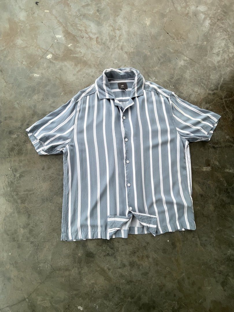 H&M Striped Short Sleeve Shirt Regular Fit Size S (Category: Tshirts & Polo Shirts ) located in Andop. Submitted by usher.thrifts (Listing ID 1468614962, Image 1). Description: - Brand: H&M - Style: Vertical stripe button-down shirt with camp collar and short sleeves - Size: S (170/92A), Regular fit - Material: 100% viscose (lightweight and breathable) - Condition: Excellent - Perfect for: Casual wear, beach days, or summer outings.