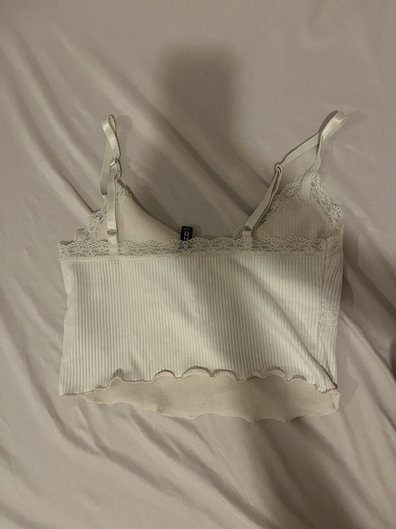 H&M White Lace Ribbed Cami Crop Top (Category: Sleeveless) located in Manila. Submitted by vees.shop (Listing ID 1468683245, Image 2). Description: - Brand: H&M - Color: White - Material: Ribbed textured fabric - Details: Delicate lace trim on V-neckline, scalloped hem, adjustable spaghetti straps - Condition: Clean and ready to wear - Versatile: Great for layering or wearing solo in warm weather - Payment Mode: Gcash or BPI.