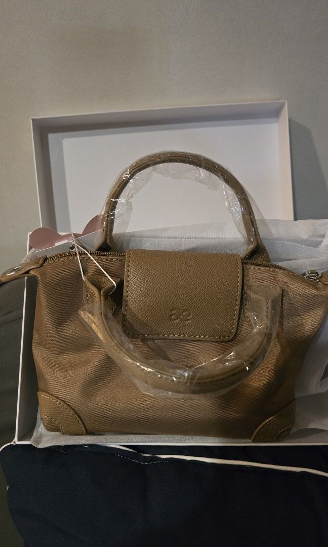 HOLB - Bnew mini sling bag (Category: Shoulder Bags) located in Pasig City. Submitted by ocmom (Listing ID 1468503740, Image 3). Description: brand: House of Little Bunny size: 9 x 5 inches can fit medium wallet adjustable strap comes with a box dust bag color: dark khaki /brown with tag made in Thailand.