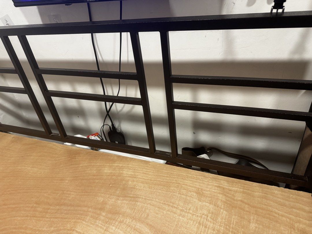 Home Suite Metal Bed Frame with Headboard (Category: Bed Frames & Mattresses) located in Valenzuela. Submitted by thecozyclosetph (Listing ID 1468647513, Image 3). Description: - Brand: Home Suite metal bed frame in a sleek dark brown finish - Support: Sturdy slatted metal base with attached wooden panel support - Headboard: High design featuring an open rectangular grid pattern - Storage: Generous under-bed clearance for boxes and equipment - Co