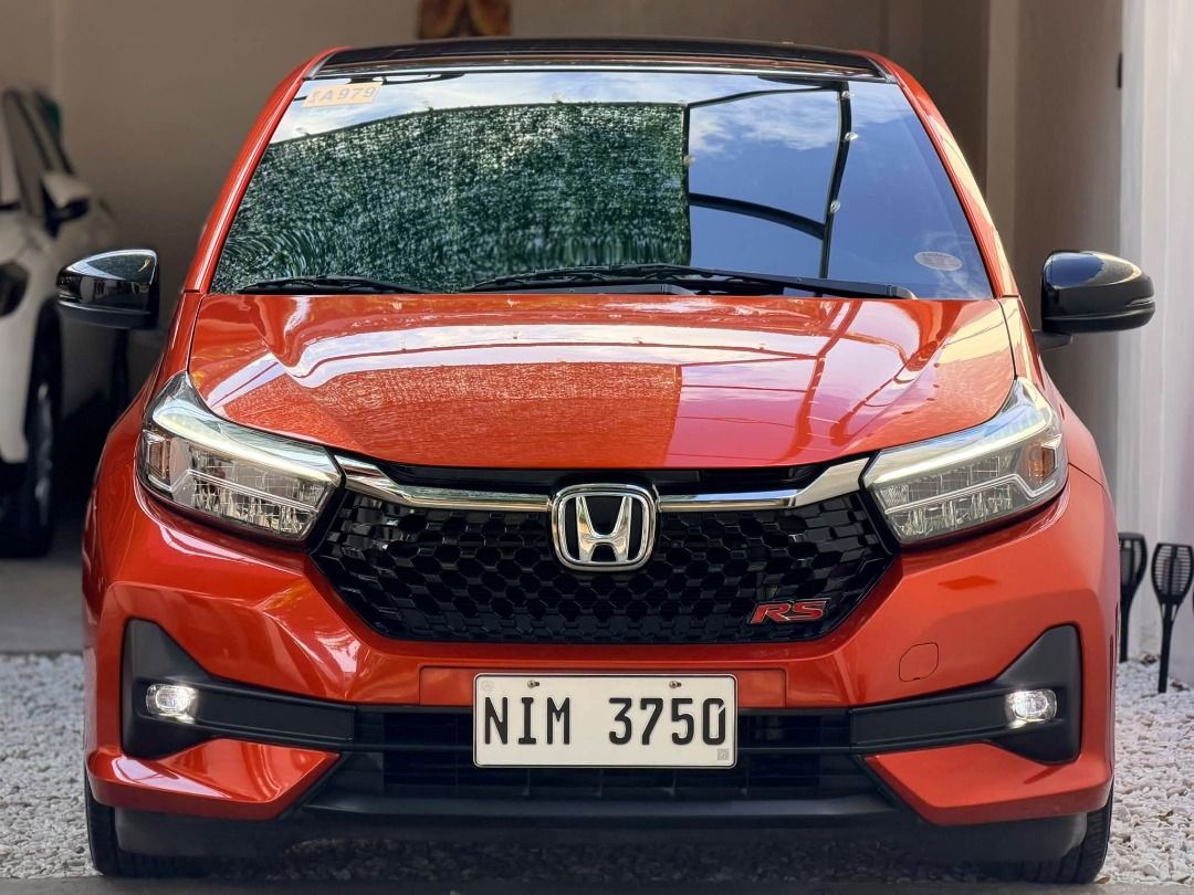 Honda Brio (Category: Used Cars) located in Quezon City. Submitted by richmond_pauli (Listing ID 1468679977, Image 2). Description: 2024 HONDA BRIO RS AT (14k Mileage) 🔥 Top-of-the-line RS variant (Black Top) in pristine condition! • Financing: ₱59K DP ONLY (1-3 Days Easy Approval) • Engine/Trans: 1.2L i-VTEC Gasoline | CVT Automatic • Features: Touchscreen (Apple CarPlay/Android Auto), Multi-Function Steering Wheel, Digital AC • Exterior: RS Bo