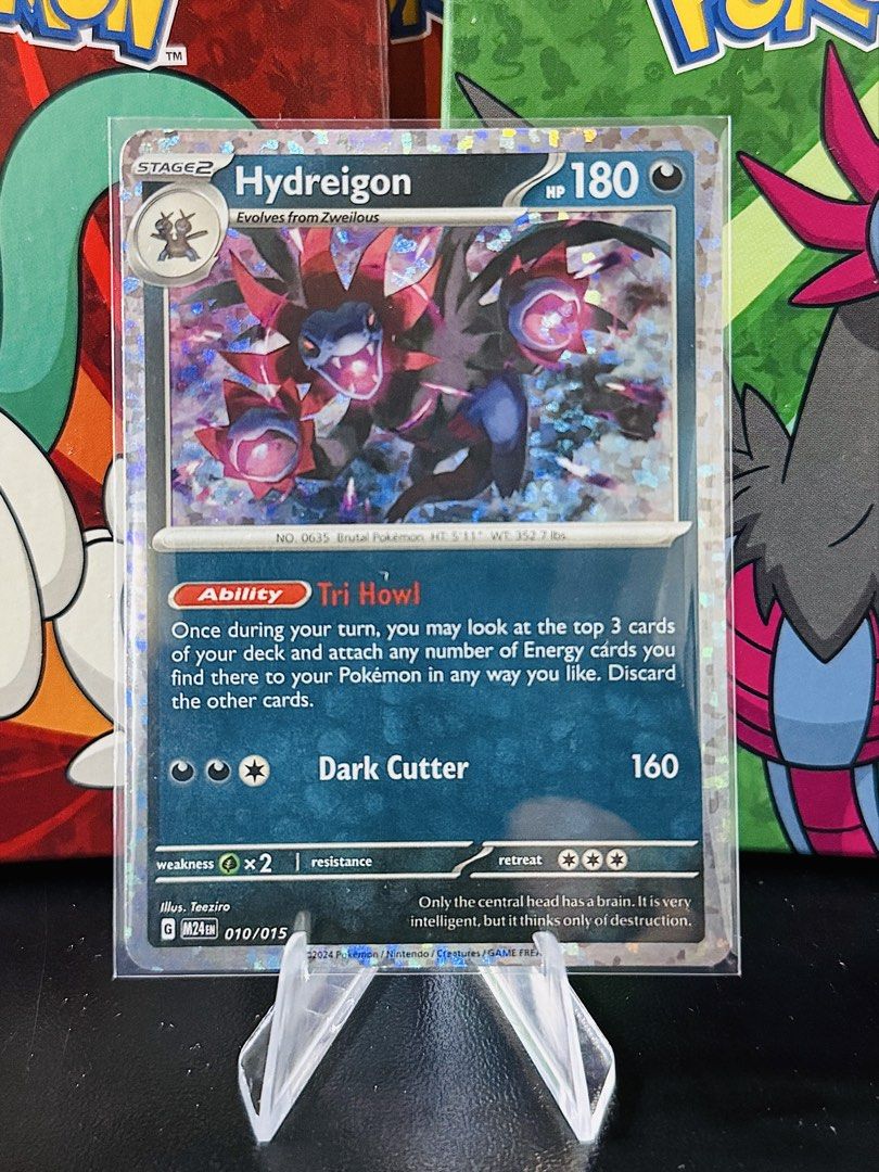 Hydreigon (Category: Raw Singles) located in Bacarra. Submitted by retrovival (Listing ID 1468708999, Image 1). Description: 🐉 Hydreigon 010/015 — M24EN For sale by piece! This Dark-type powerhouse features 180 HP, the Tri Howl Ability, and a cool holographic finish. Sleeved and ready for its next trainer. ✨.