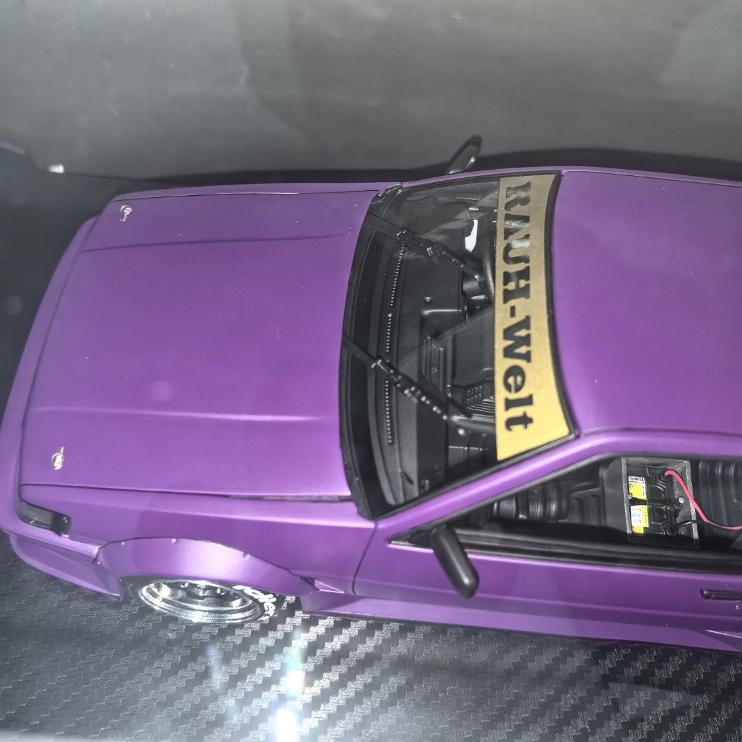 Ignition Model RWB AE86 Purple Saber Tiger (Category: Vehicle & Diecast Models) located in Mandaluyong City. Submitted by ecq_sale (Listing ID 1468667962, Image 2). Description: - Brand/Scale: Ignition Model 1/18 scale diecast car - Color/Design: Purple body paint with official RAUH-Welt Begriff windshield and rear spoiler graphics - Customization: Aggressive wide body kit, deep dish wheels, and installed interior roll cage - Condition/Inclusions