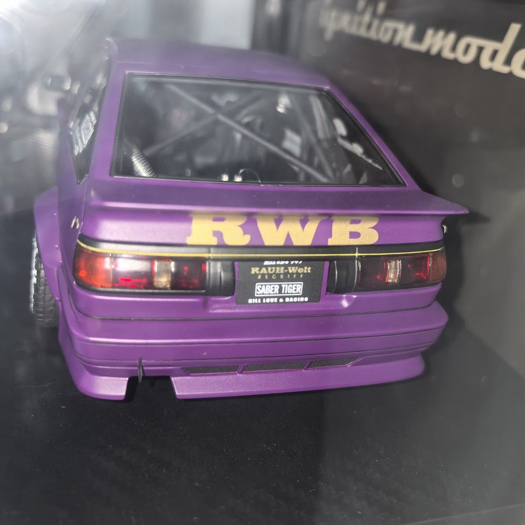 Ignition Model RWB AE86 Purple Saber Tiger (Category: Vehicle & Diecast Models) located in Mandaluyong City. Submitted by ecq_sale (Listing ID 1468667962, Image 3). Description: - Brand/Scale: Ignition Model 1/18 scale diecast car - Color/Design: Purple body paint with official RAUH-Welt Begriff windshield and rear spoiler graphics - Customization: Aggressive wide body kit, deep dish wheels, and installed interior roll cage - Condition/Inclusions