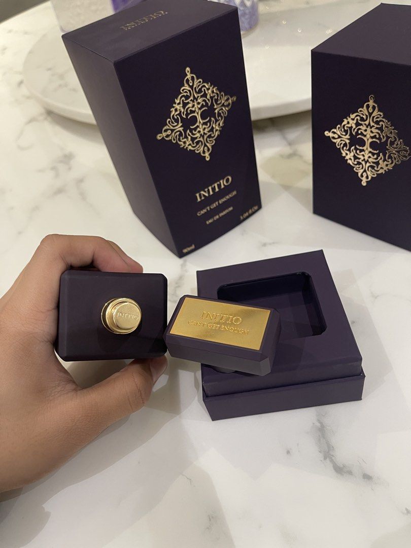 Initio Parfums Prives Can't Get Enough Eau de Parfum 90ml (Category: Fragrance & Deodorants) located in Rodriguez. Submitted by calumn (Listing ID 1468679021, Image 3). Description: - Brand: Initio Parfums Prives - Fragrance: Can't Get Enough Eau de Parfum - Size: 90ml - Condition: few missing sprays - Packaging: Includes original purple and gold box with inner display stand - Scent Profile: Rich and captivating niche fragrance - 100% authentic a