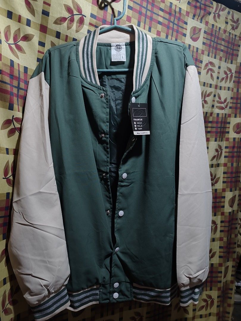 INSPI Green and Cream Varsity Jacket Size L (Category: Coats, Jackets and Outerwear) located in Bauang. Submitted by chrisquinto2004 (Listing ID 1468676601, Image 1). Description: - Brand: INSPI - Style: Varsity Jacket - Color: Green and Cream - Size: L (Tag still attached) - Closure: Button-up front - Details: Striped ribbed collar, cuffs, and hem with solid color contrast sleeves - Condition: Brand new with tag on pocket.