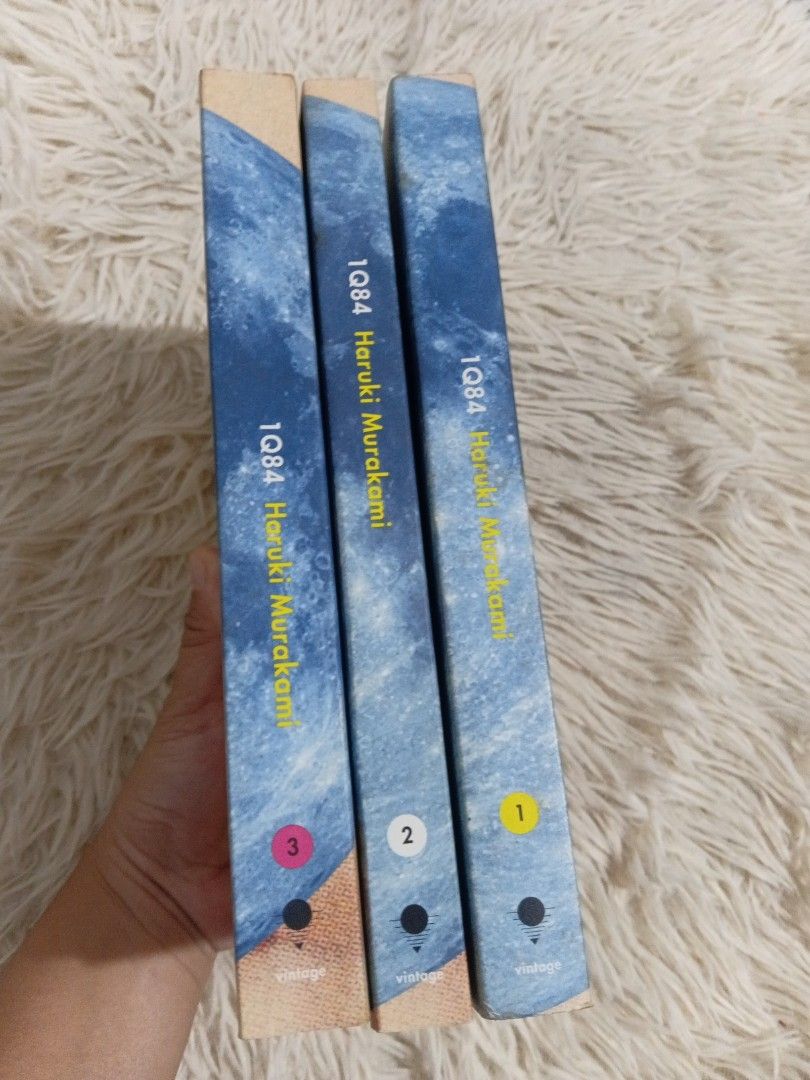 IQ84 Trilogy by Haruki Murakami (Category: Storybooks) located in Cavite. Submitted by nathstelein_finds (Listing ID 1468648818, Image 3). Description: - Complete set: Books 1, 2, and 3 of IQ84 by Haruki Murakami - Edition: Vintage paperback with the iconic surreal moon and eye cover art - Condition: Clean pages with minor shelf wear on edges - Perfect for: Murakami fans and readers exploring Japanese literature.