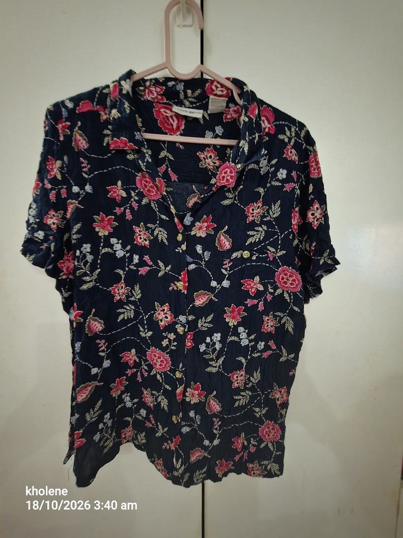 Jaclyn Smith Navy Blue Floral Button Down Blouse Large (Category: Blouses) located in Puerto Princesa. Submitted by kholene (Listing ID 1468704727, Image 1). Description: - Brand: Jaclyn Smith - Style: Short-sleeve button-down shirt with classic collar - Size: Large - Color/Pattern: Navy blue base with all-over pink, red, white, and blue floral print - Material: Lightweight rayon - Condition: Great for casual everyday wear.