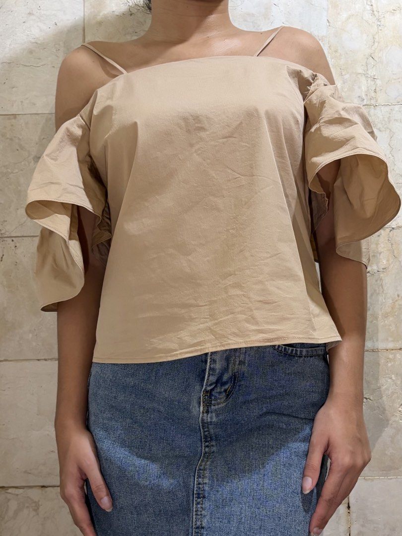 Jacquemus Chic Beige Off-Shoulder Top, Elevated Basics (Category: Blouses) located in Quezon City. Submitted by by__rosie (Listing ID 1468594107, Image 3). Description: Jacquemus Le Nez Rouge beige off-shoulder top with cute ruffle sleeves, thin straps, and a straight neckline. 🫶 Fits S-M 💐Mode of Payment: GCash 💐 Shipping: Via Lalamove (Buyer shoulders shipping fee).