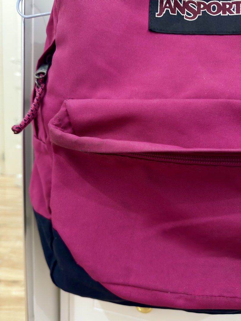JanSport Pink and Navy Blue Backpack (Category: Backpacks) located in Manila. Submitted by chi.declutter (Listing ID 1468515628, Image 2). Description: - Brand: JanSport - Color: Pink and Navy Blue - Material: Durable canvas fabric - Compartments: Large main compartment and front zip pocket - Details: Classic square logo patch and top haul loop - Best for: School, travel, and everyday use Free delivery for those who will avail 5 items and above..