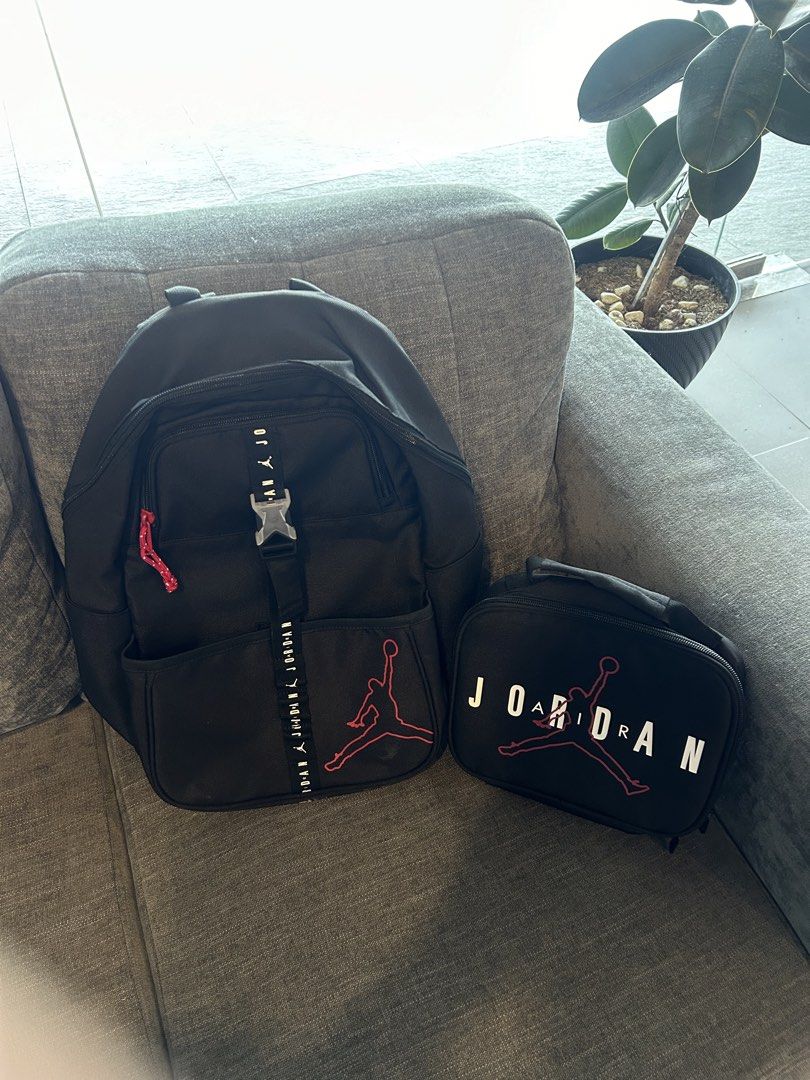 Jordan Black and Red Backpack with Lunch Bag Set (Category: Babies & Kids Fashion) located in San Fernando. Submitted by aljames1623 (Listing ID 1468576397, Image 2). Description: - Authentic Jordan backpack and matching lunch bag bundle - Sleek black design with iconic red Jumpman graphics and branded straps - Backpack features a secure front buckle closure - Lunch box showcases bold Jordan lettering across the front - Ideal set for school, spor