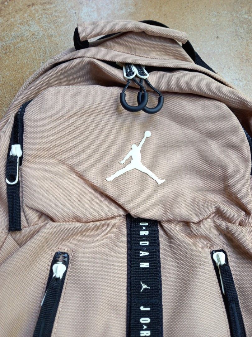 Jordan Jumpman Tan Backpack (Category: Backpacks) located in Davao. Submitted by kirk214red-50020 (Listing ID 1468530637, Image 2). Description: - Color: Tan - Iconic Jumpman logo and branded webbing strap on the front - Multiple zipper compartments for easy organization - Dedicated interior laptop sleeve and organizer pockets - Padded mesh back and shoulder straps for all-day comfort - Clean interior lining with original tag intact.