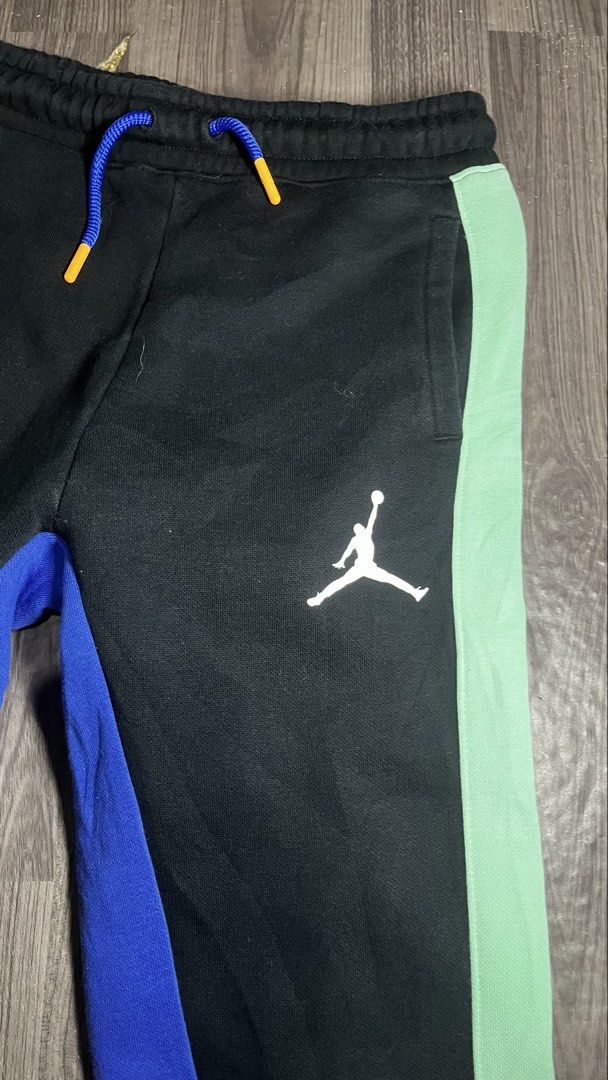 Jordan Multi-Color Panel Sweatpants Kids Size S (Category: Joggers) located in Caloocan City. Submitted by lucky_jhonel (Listing ID 1468658400, Image 3). Description: - Brand: Jordan - Color: Black with yellow, blue, and mint green side panels - Details: White Jumpman logo on left thigh, blue drawstrings with orange aglets - Fit: Elastic waistband and ribbed ankle cuffs - Material: 65% cotton, 35% polyester (machine washable).