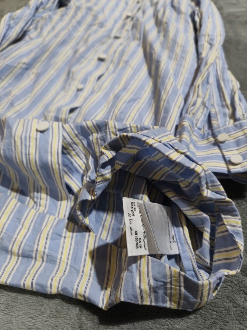 Juicy Couture (Category: Dresses) located in Bacolod City. Submitted by loothingsph (Listing ID 1468679095, Image 3). Description: - Brand: Juicy Couture Black Label - Style: Vertical stripe shirt dress with matching fabric belt - Color: Blue, white, and yellow - Size: XS - Details: Long sleeves, button-up front, classic collar, curved hemline, and branded white buttons on front and cuffs - Mode of Payment: GCash or BPI - Shipping: Fast shipping 