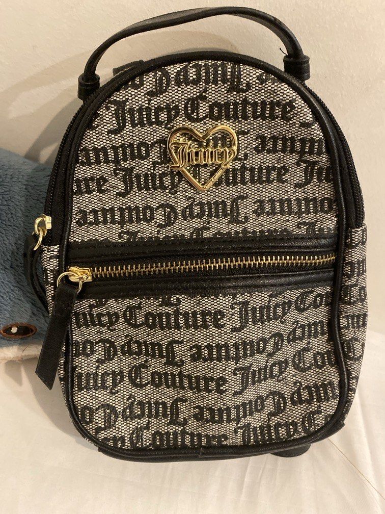 Juicy Couture Backpack (Category: Luxury Bags & Wallets) located in Quezon City. Submitted by pixavix (Listing ID 1468667286, Image 2). Description: - Brand: Juicy Couture - Style: Small Backpack / Mini Backpack - Color/Design: Black & White monogram pattern with black trim - Hardware: Gold-tone accents, featuring a signature gold heart logo on the front pocket - Interior: Branded fabric lining with an inner zip pocket for small essentials - Cond