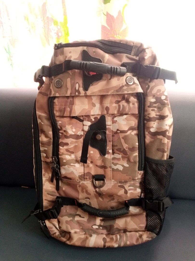 Kaka Multifunctional Camouflage Travel Backpack with Multiple Handles (Category: Backpacks) located in General Trias. Submitted by dwyane09 (Listing ID 1468551016, Image 2). Description: - Earth-tone camouflage design for a rugged look - Heavy-duty construction featuring top and side grab handles - Multiple zipped compartments and front pockets for easy organization - Adjustable shoulder straps with D-rings and side mesh water bottle holder - Com