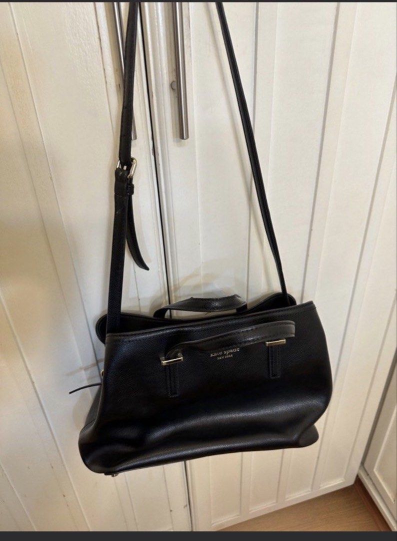 Kate Spade Black Leather Tote Bag (Category: Tote Bags) located in San Fernando. Submitted by tintinpuno (Listing ID 1468516939, Image 2). Description: - Brand: Kate Spade New York - Color: Classic Black - Material: Premium Leather - Hardware: Silver-tone with front stamped logo - Straps: Double top handles and adjustable shoulder strap - Interior: Spacious compartments for daily essentials, work, and travel - Condition: Excellent, versatile ever