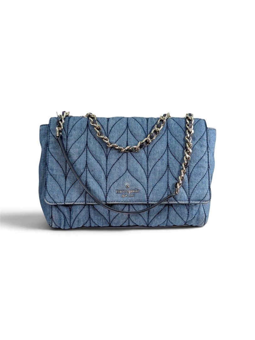 Kate Spade Denim Quilted Shoulder Bag (Category: Luxury Bags & Wallets) located in Alburquerque. Submitted by ukaydecebuofficial (Listing ID 1468517027, Image 1). Description: - Brand: Kate Spade New York - Material: Quilted blue denim with chevron stitch pattern - Hardware: Silver-tone metal logo plate - Closure: Flap closure - Strap: Chain strap interwoven with dark leather - Interior: Black fabric lining with spade and heart motifs, includes b