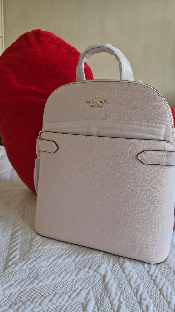 Kate Spade New York Backpack Light Pink (Category: Backpacks) located in Makati City. Submitted by 29mtp (Listing ID 1468710219, Image 3). Description: - Brand: Kate Spade New York - Color: Light Pink - Material: Premium Saffiano leather - Hardware: Elegant gold lettering logo and accents - Storage: Convenient front slip pocket with decorative trim tabs - Condition: Brand new with original swing tag attached - Details: Top handle and adjustable s