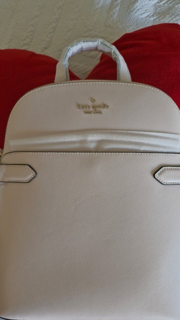 Kate Spade New York Backpack Light Pink (Category: Backpacks) located in Makati City. Submitted by 29mtp (Listing ID 1468710219, Image 1). Description: - Brand: Kate Spade New York - Color: Light Pink - Material: Premium Saffiano leather - Hardware: Elegant gold lettering logo and accents - Storage: Convenient front slip pocket with decorative trim tabs - Condition: Brand new with original swing tag attached - Details: Top handle and adjustable s