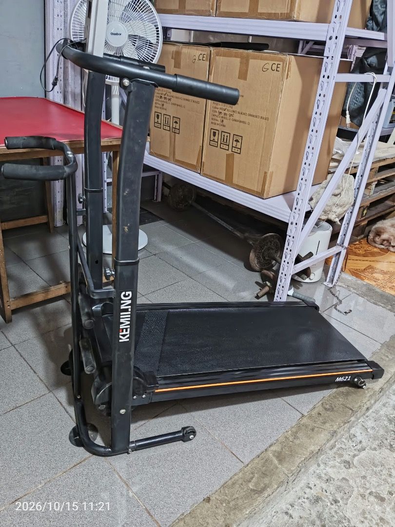 Kemilng Black Folding Manual Treadmill (Category: Cardio & Fitness Machines) located in Cainta. Submitted by janinayy29 (Listing ID 1468501972, Image 3). Description: - Color: Sleek black with an eye-catching orange stripe accent - Compact & Space-Saving: Ideal for home workouts and easy storage with a built-in folding mechanism - Tracking & Support: Equipped with a built-in front monitor panel and side handlebars - Durable Build: Sturdy metal co
