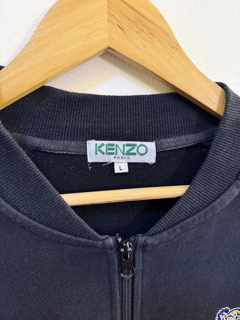 Kenzo Paris Black Bomber Jacket with Tiger Embroidery (Category: Coats, Jackets and Outerwear) located in Paranaque City. Submitted by mykapoynton (Listing ID 1468703077, Image 3). Description: - Brand: Kenzo Paris - Style: Zip-up jacket - Size: L - Color: Black - Origin: Made in Portugal - Design: Large colorful embroidered tiger graphic on the back, smaller tiger patch on the front chest, and white logo taping along both sleeves - Features: Rib