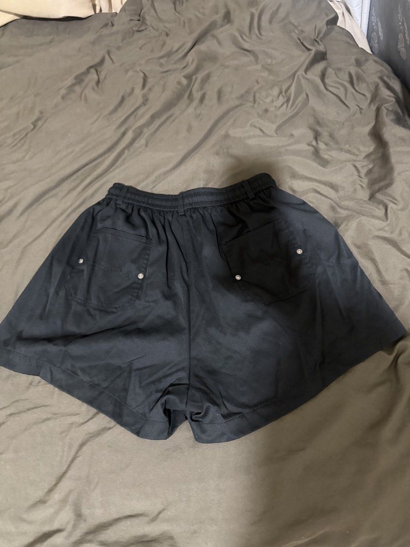 Kiabi Black Cargo Shorts Size XL (Category: Shorts) located in Quezon City. Submitted by turtleandfishes (Listing ID 1468675551, Image 3). Description: - Brand/Model: Kiabi Black Cargo Shorts - Size: XL - Waist: Approx. 15 inches across (with elastic waistband & drawstring) - Length: Approx. 19 inches total - Details: Button fly, front flap pockets with metal accents, and back pockets - Style: Casual everyday wear, easy to pair with tees and tank