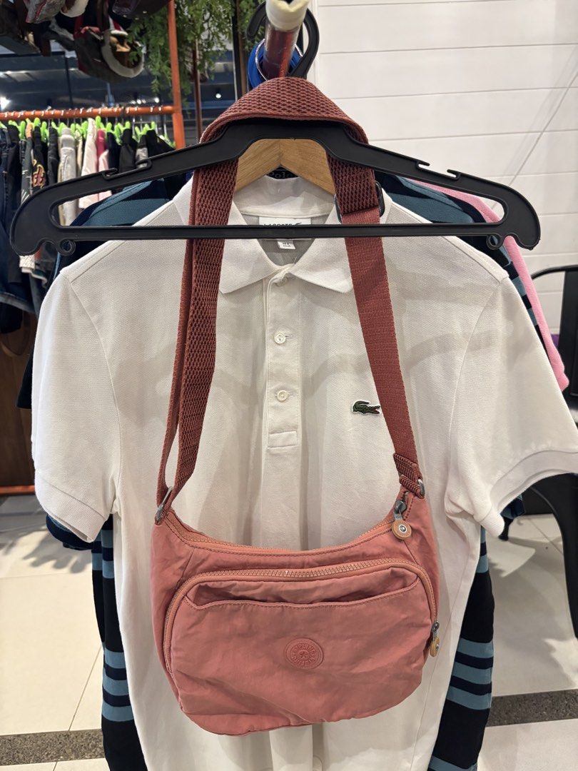 Kipling KI2587-47G Dusty Pink Shoulder Bag (Category: Shoulder Bags) located in Manila. Submitted by jeromskito66462 (Listing ID 1468676501, Image 1). Description: - Brand: Kipling - Model: KI2587-47G - Color: Dusty Pink - Material: Durable nylon (Made in Cambodia) - Exterior: Front zip pocket with round logo patch, adjustable strap - Interior: Cream polka dot lining, zip pocket, and brand logo tag - Condition: Clean inside and out, excellent rea